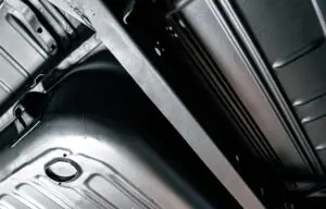 Close-up of a clean satin-black vehicle underbody finish with a smooth protected appearance.