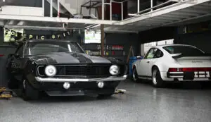Classic enthusiast vehicles inside Merritt Motors shop.